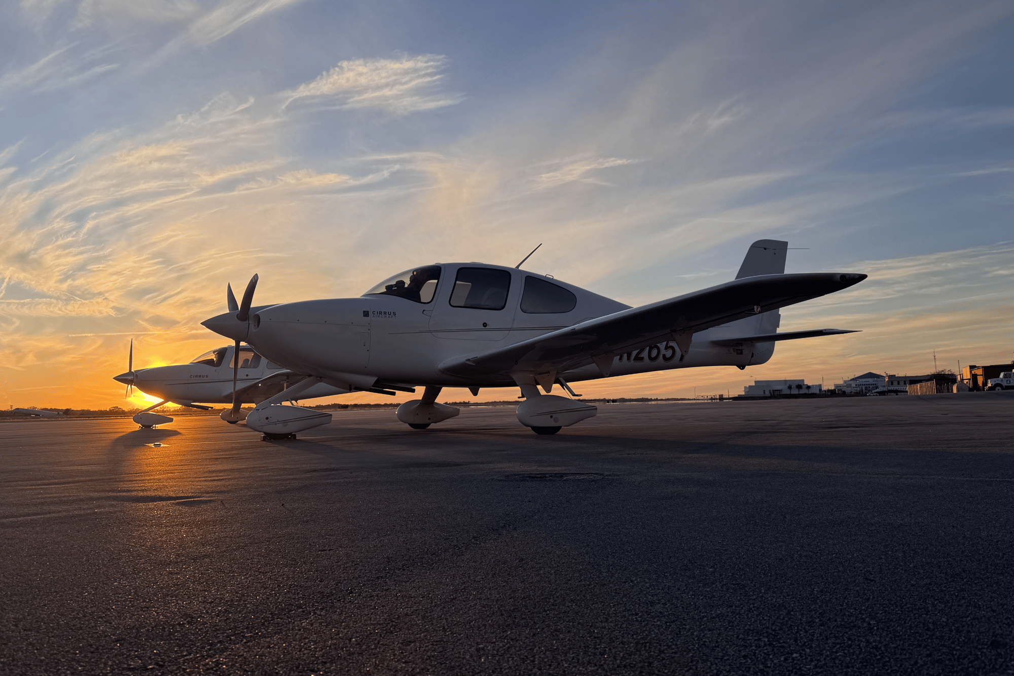 CIRRUS AIRCRAFT ON RAMP AT SUNSET